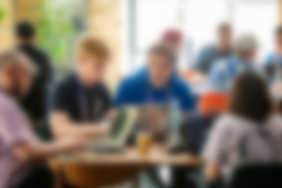 A group of developers are sitting by their computers hacking at Codegarden